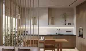 Drewniane przepierzenie oddziela salon od kuchni z jadalnią. W kuchni widać drewniane szafki, zlew i piekarnik.